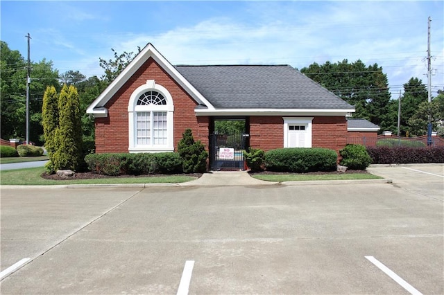 4011 Charrwood Trce, Marietta, GA 30062 - view of front of property featuring brick siding, a gate, a shingled roof, and uncovered parking
