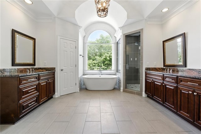 4011 Charrwood Trce, Marietta, GA 30062 - bathroom featuring a stall shower, two vanities, ornamental molding, a freestanding bath, and recessed lighting