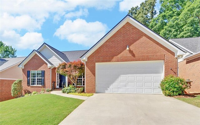 view of front of property with a front yard and a garage