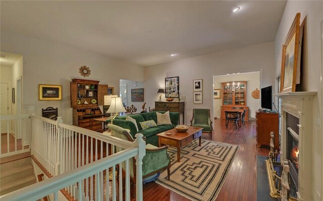 living room featuring a chandelier and dark wood-type flooring