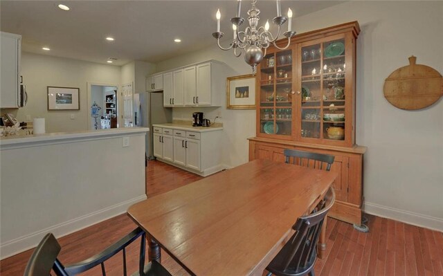 dining space featuring light hardwood / wood-style flooring and an inviting chandelier