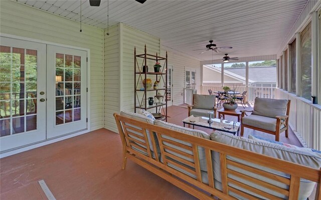 sunroom / solarium with a healthy amount of sunlight, ceiling fan, and french doors