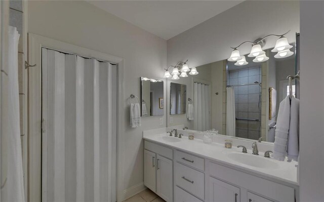 bathroom with tile patterned floors, vanity, and curtained shower