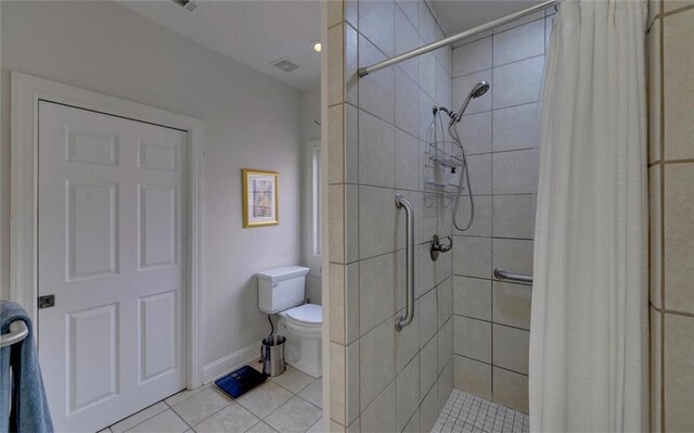 bathroom with tile patterned flooring, a shower with curtain, and toilet