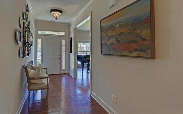 foyer with dark hardwood / wood-style floors and crown molding