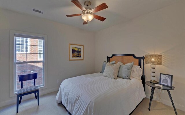 bedroom with ceiling fan and light colored carpet