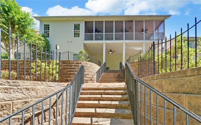 view of front of home featuring a balcony and ceiling fan