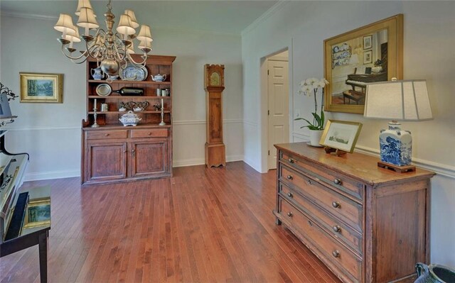 interior space with dark hardwood / wood-style floors, a chandelier, and crown molding