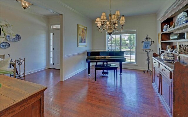 dining area featuring ornamental molding, dark hardwood / wood-style flooring, and a notable chandelier