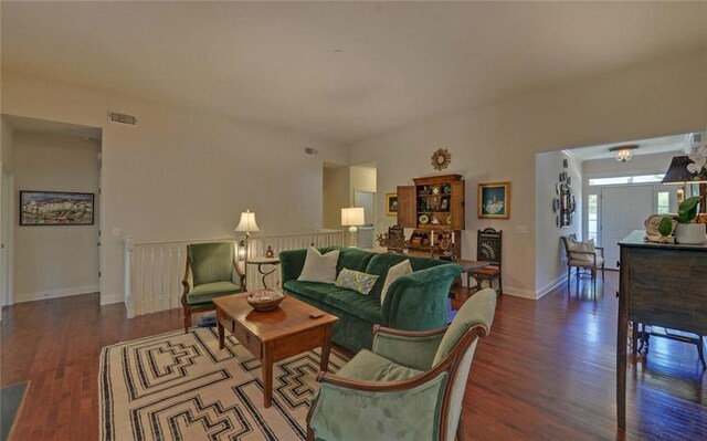 living room with dark hardwood / wood-style flooring