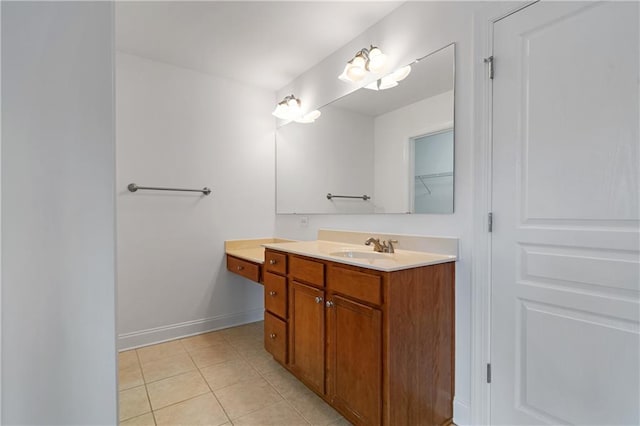 bathroom with tile patterned floors, baseboards, and vanity