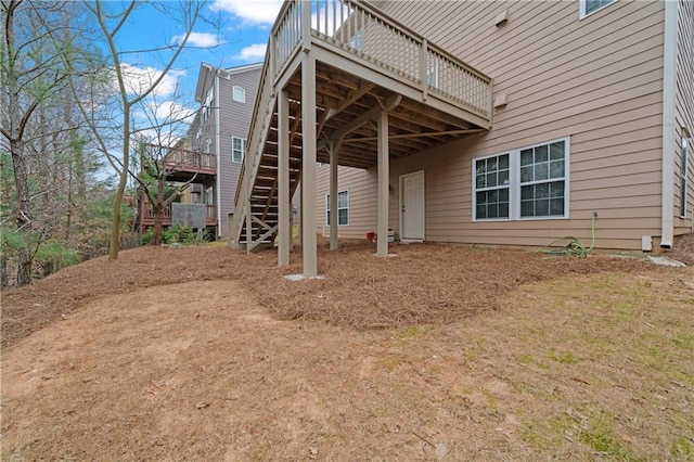 back of property featuring a deck and stairway