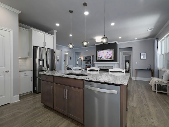 712 Broken Arrow, Waleska, GA 30183 - kitchen featuring appliances with stainless steel finishes, crown molding, dark wood-type flooring, an island with sink, and white cabinets