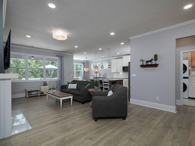 712 Broken Arrow, Waleska, GA 30183 - living area featuring stacked washer and clothes dryer, ornamental molding, recessed lighting, and wood finished floors