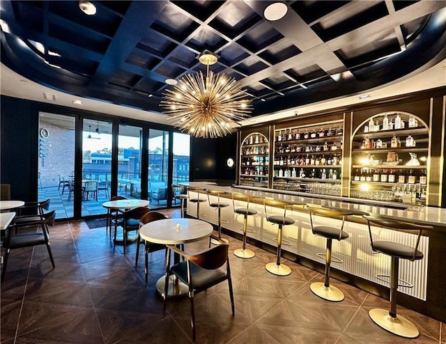 bar with a notable chandelier, coffered ceiling, and wet bar