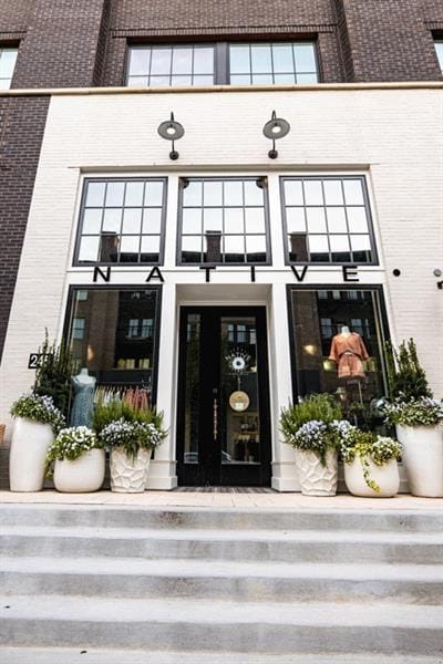 view of exterior entry featuring brick siding