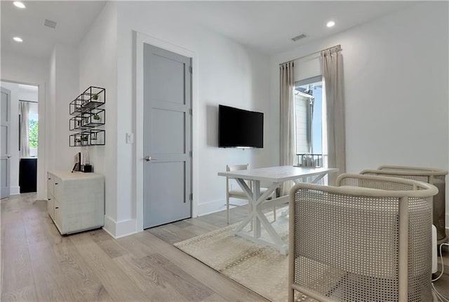 interior space with baseboards, visible vents, light wood-style flooring, and recessed lighting