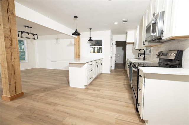 4336 Parkview Dr, Lithia Springs, GA 30122 - kitchen featuring visible vents, a peninsula, tasteful backsplash, appliances with stainless steel finishes, and white cabinetry