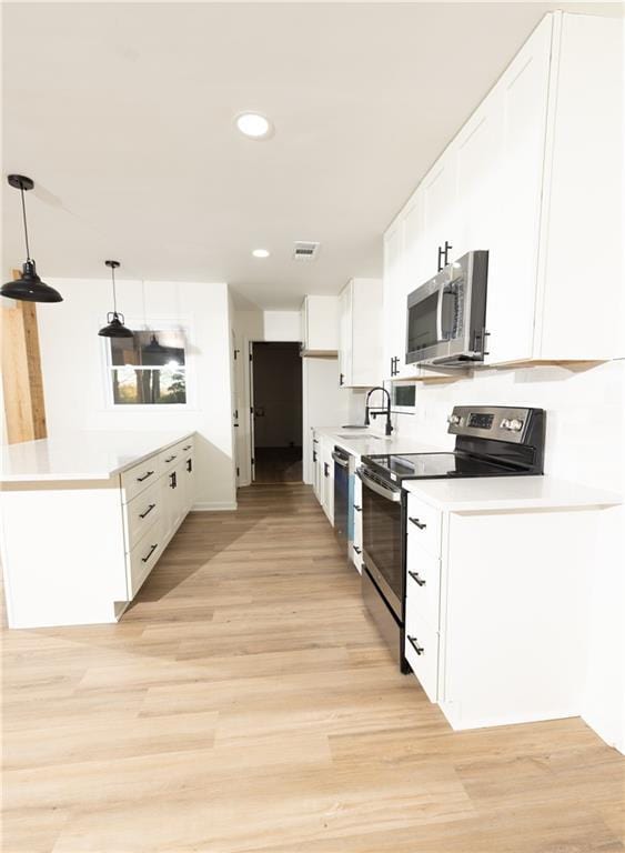 4336 Parkview Dr, Lithia Springs, GA 30122 - kitchen featuring a sink, white cabinetry, appliances with stainless steel finishes, visible vents, and light wood-style floors