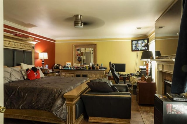 bedroom featuring ceiling fan, a fireplace, and ornamental molding