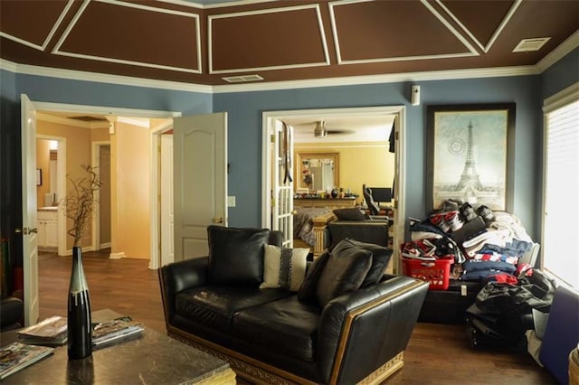 home theater featuring crown molding and dark wood-type flooring