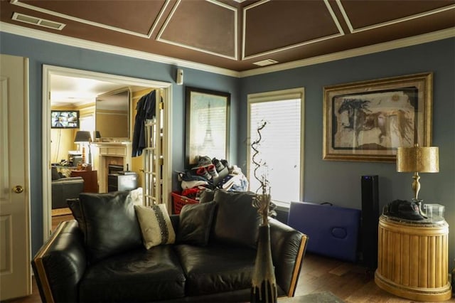 living room featuring hardwood / wood-style floors and crown molding