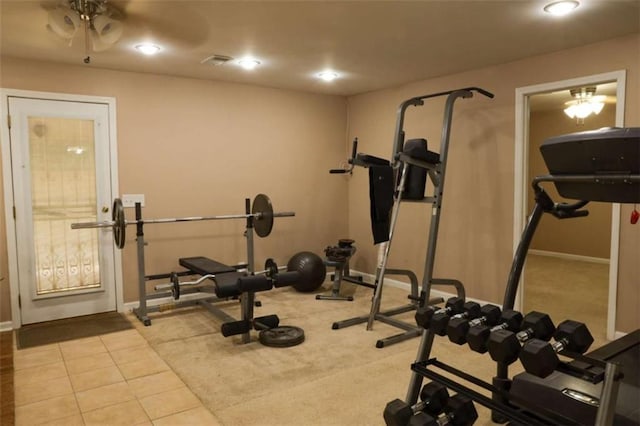 exercise area with ceiling fan and light tile patterned floors