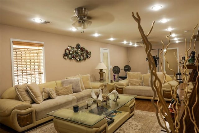 living room with ceiling fan and light hardwood / wood-style flooring