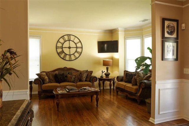 living room featuring a wealth of natural light, ornamental molding, and hardwood / wood-style flooring