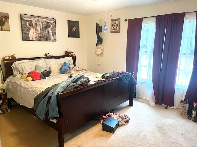 carpeted bedroom featuring multiple windows