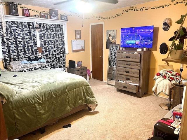 bedroom featuring ceiling fan and carpet