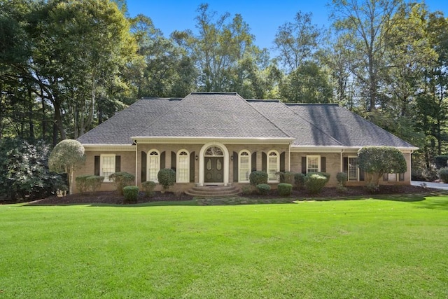 ranch-style home featuring a front yard