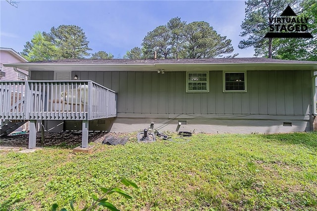 view of home's exterior with a yard, a wooden deck, and crawl space