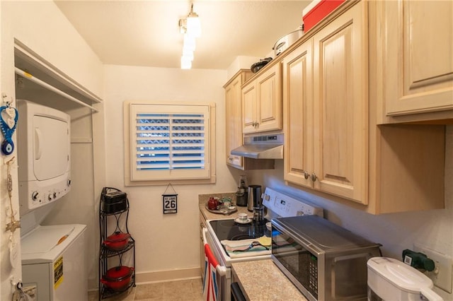 kitchen with stove, stacked washer and dryer, light tile patterned floors, and light brown cabinetry