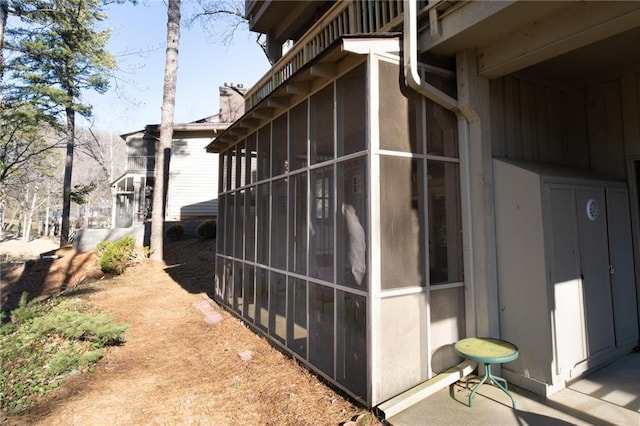 view of home's exterior with a sunroom