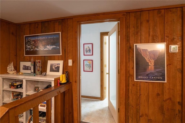 hallway featuring wood walls