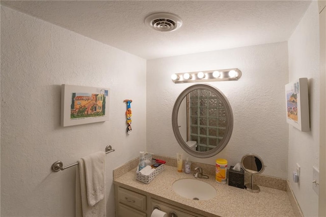 bathroom with vanity and a textured ceiling