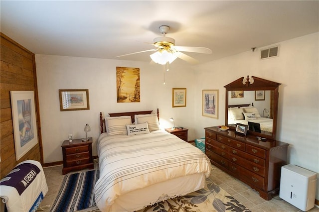 tiled bedroom with heating unit and ceiling fan