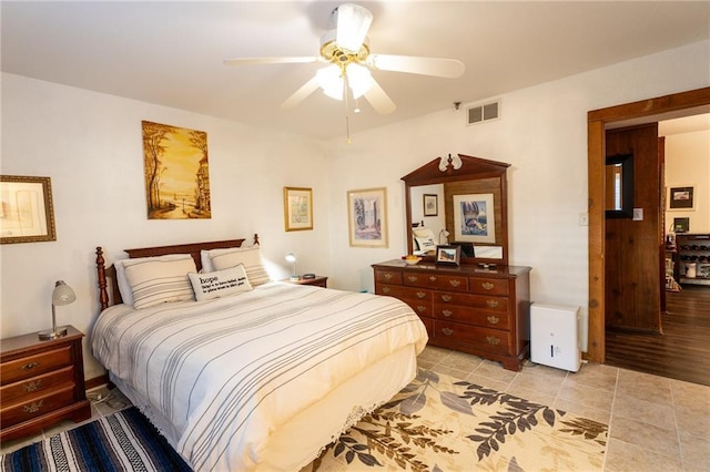 bedroom featuring light tile patterned floors and ceiling fan