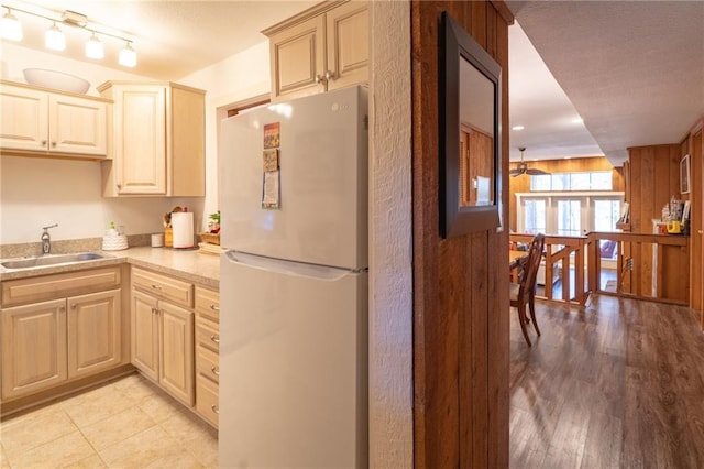 kitchen with sink, light wood-type flooring, and white fridge