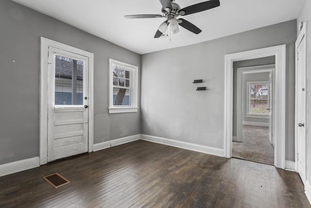 entrance foyer with baseboards, visible vents, ceiling fan, and wood finished floors