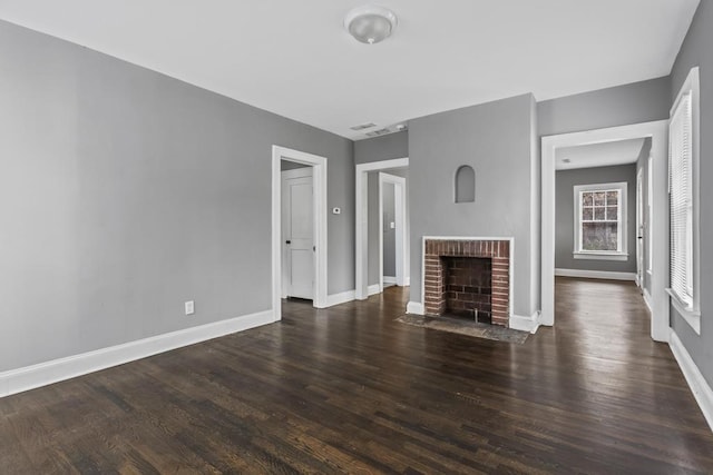 unfurnished living room with a fireplace, baseboards, and dark wood finished floors