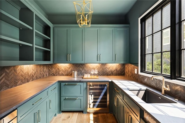 555 Orme Cir NE, Atlanta, GA 30306 - kitchen featuring green cabinetry, wine cooler, a sink, and a chandelier