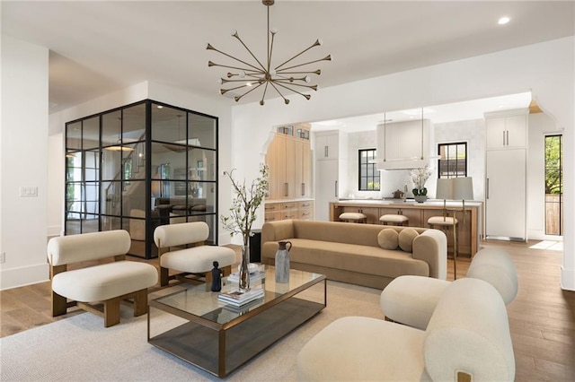 555 Orme Cir NE, Atlanta, GA 30306 - living room featuring light wood-style flooring, a chandelier, baseboards, and recessed lighting