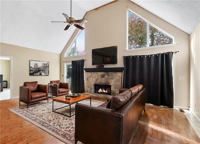 living room with wood-type flooring, high vaulted ceiling, and a wealth of natural light