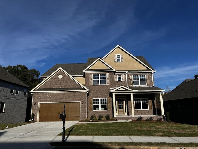 craftsman inspired home featuring a garage and a front lawn