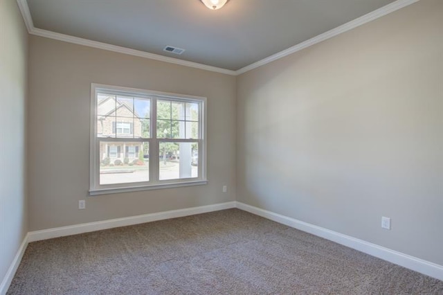 carpeted empty room featuring crown molding