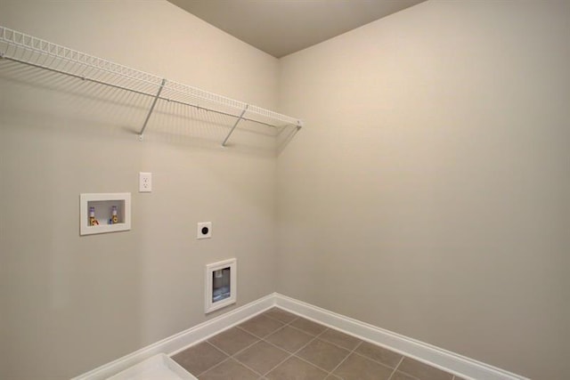 laundry room featuring hookup for a washing machine, baseboards, hookup for an electric dryer, laundry area, and dark tile patterned flooring