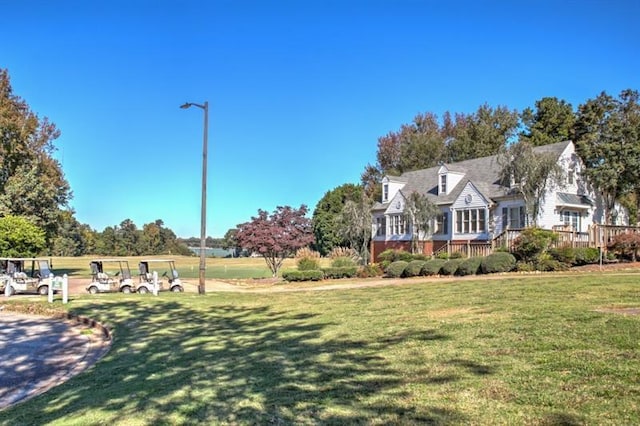 view of front facade featuring a deck and a front yard