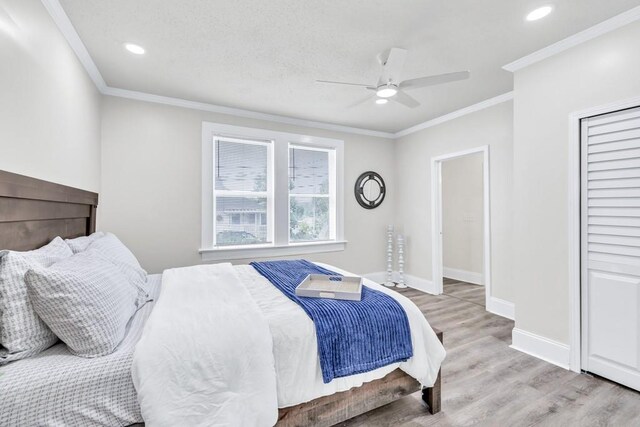 11 Poplar St, Porterdale, GA 30014 - bedroom with light wood-type flooring, crown molding, baseboards, a ceiling fan, and recessed lighting